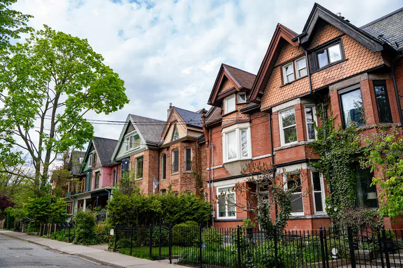 Victorian brick row houses on a leafy street